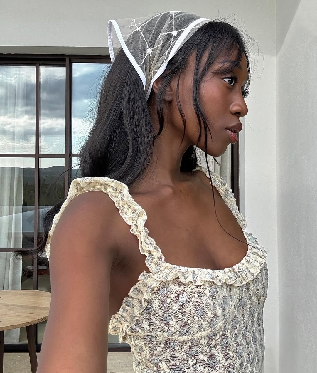 woman wearing lace top with white handkerchief in hair