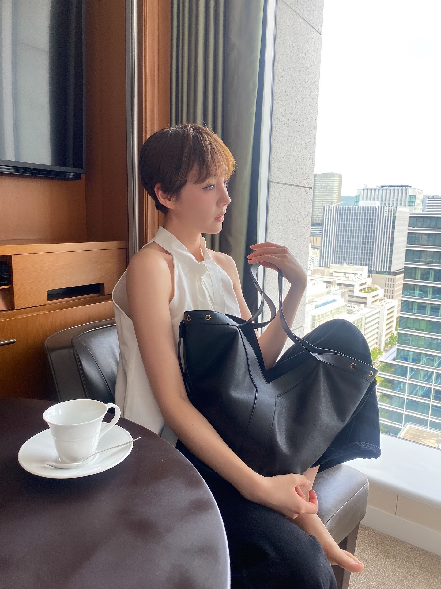 Photo of Reina Triendl in Tokyo wearing white poplin tank top.