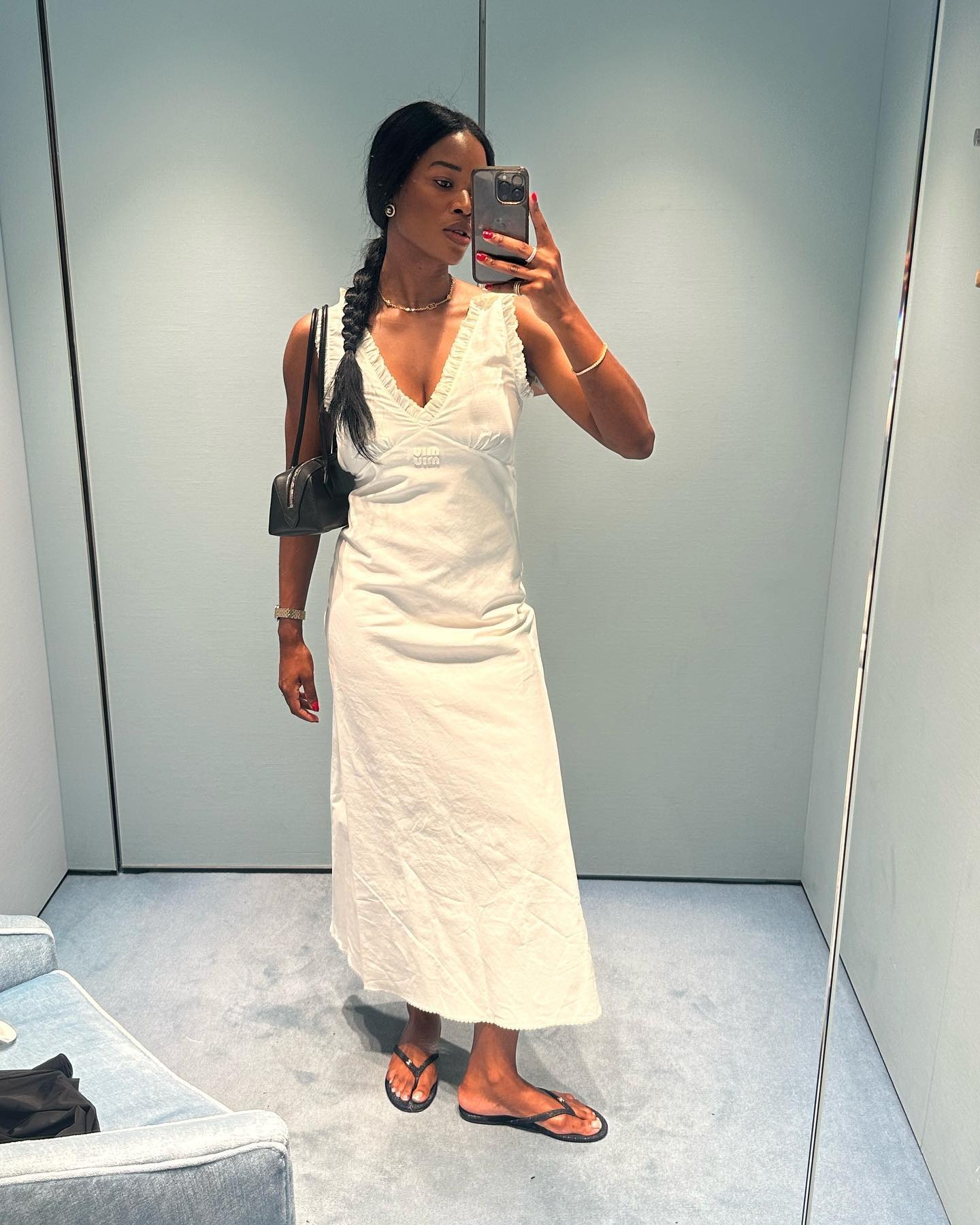 @nlmarilyn wearing a white Miu Miu nightgown dress with a shoulder bag and flip flops.