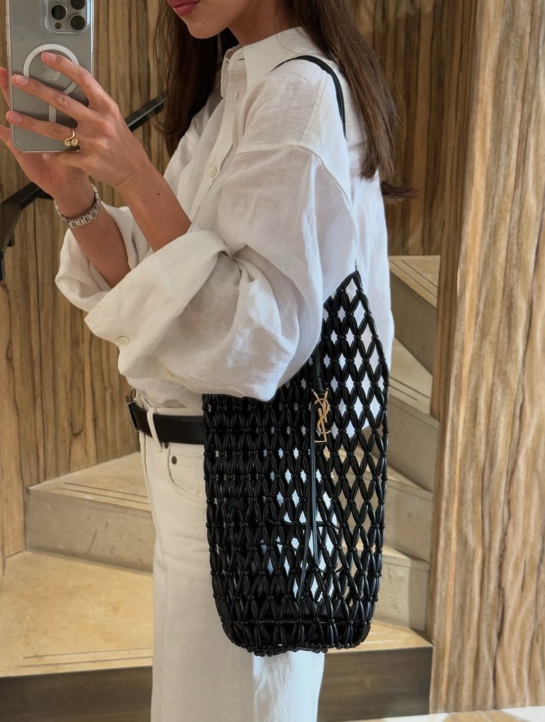 Woman holding the Saint Laurent Cassandre Tote.