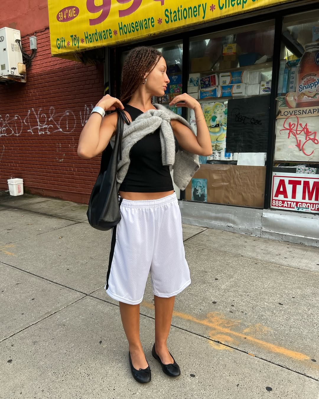 An influencer wearing gym shorts and a tank top.