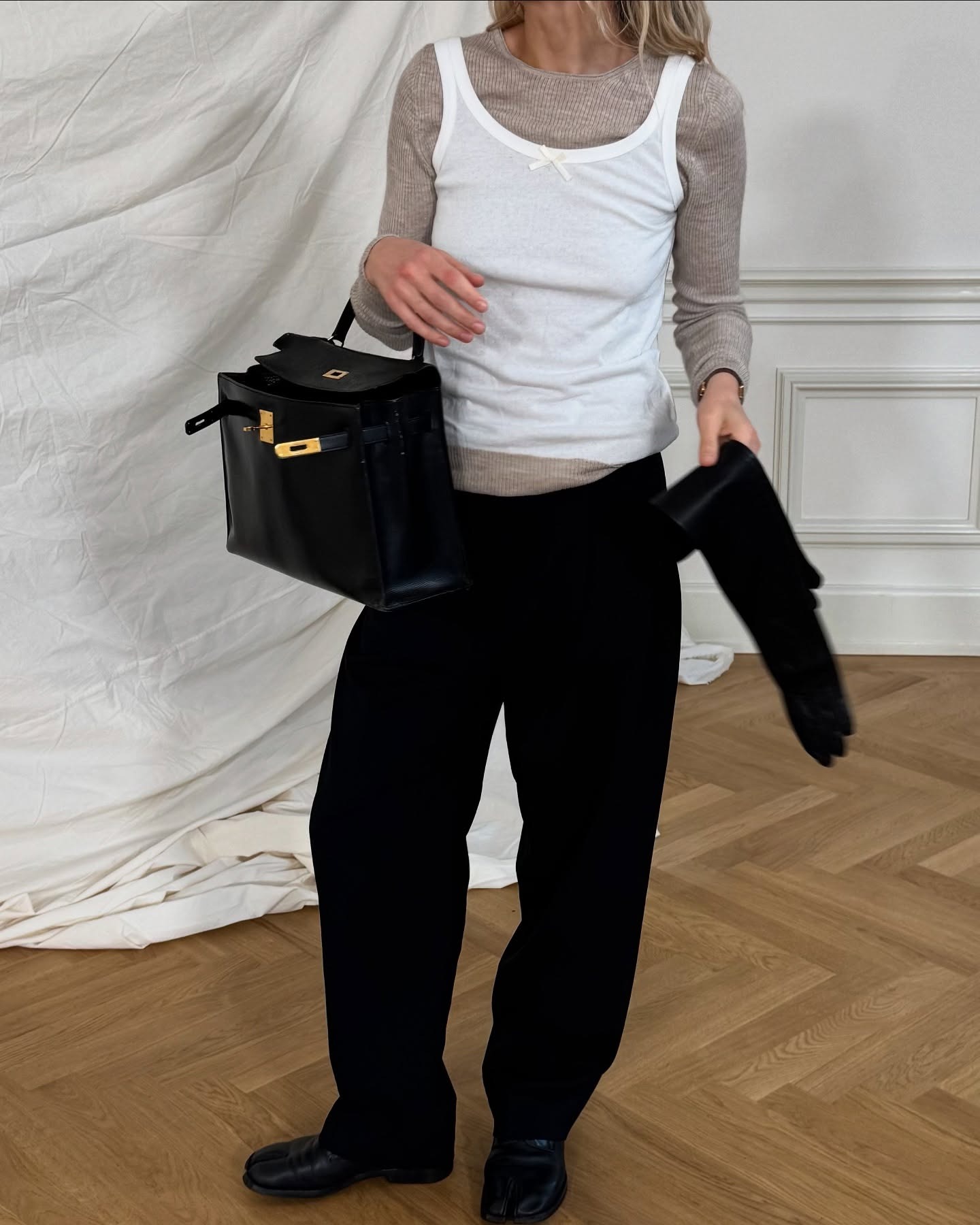 Stephanie Broek wearing a long sleeve tee with a tank on top and black trousers.