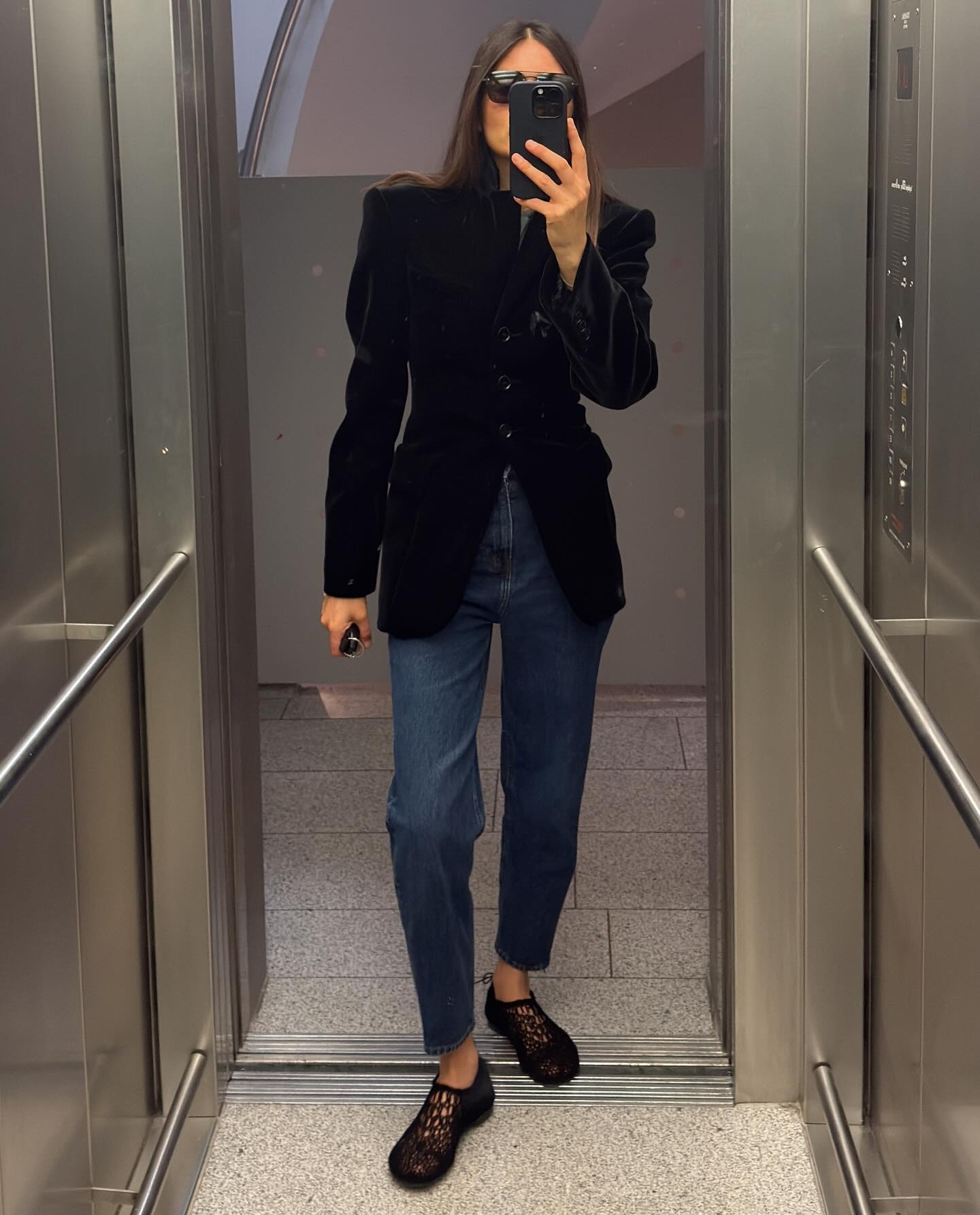 @majawyh wearing a black jacket, jeans, and black crochet flats.