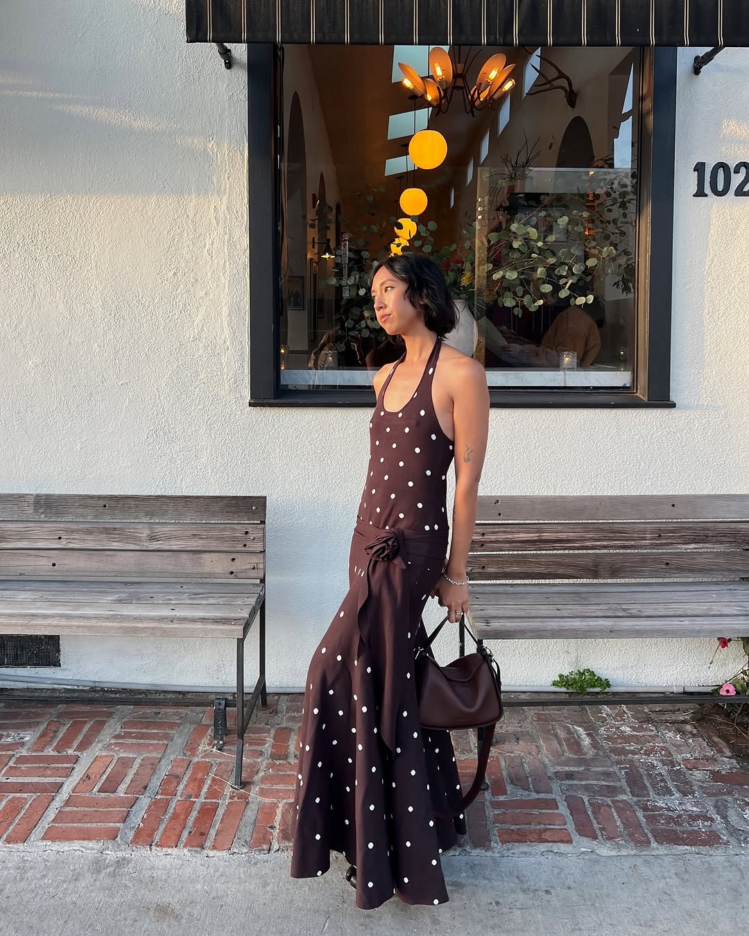 woman wearing polka dot dress with rosette detail