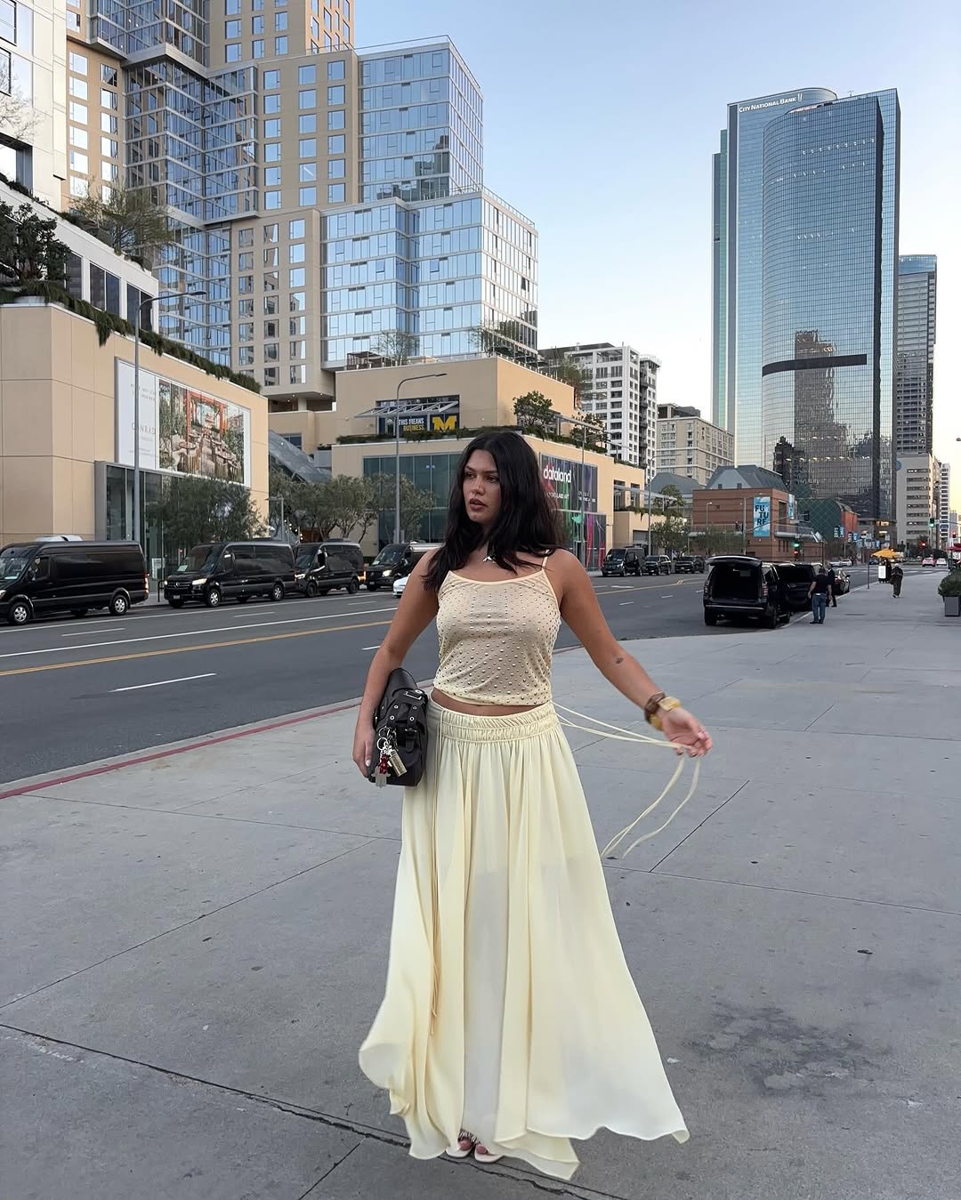 woman wearing long yellow sheer skirt with tank