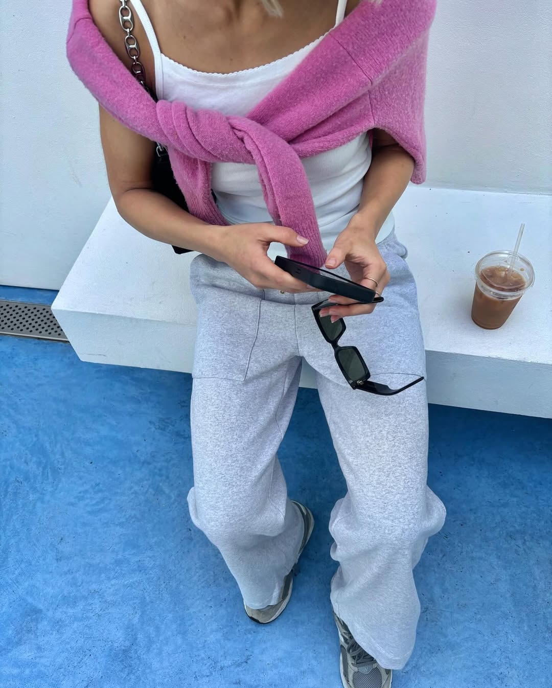 Woman wearing sweater styling idea for summer 2025.