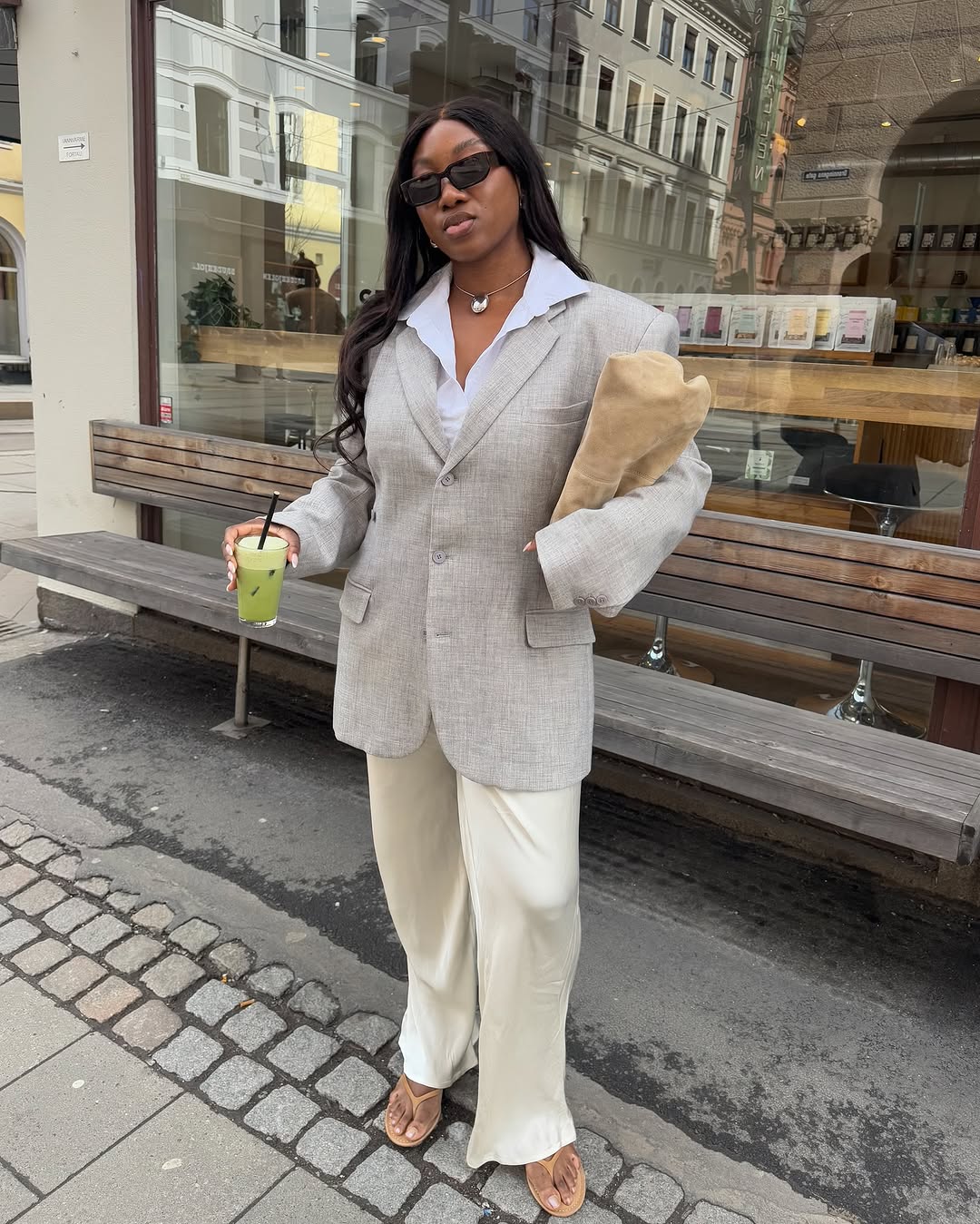 Woman wearing trouser pants and flip flops summer 2025.