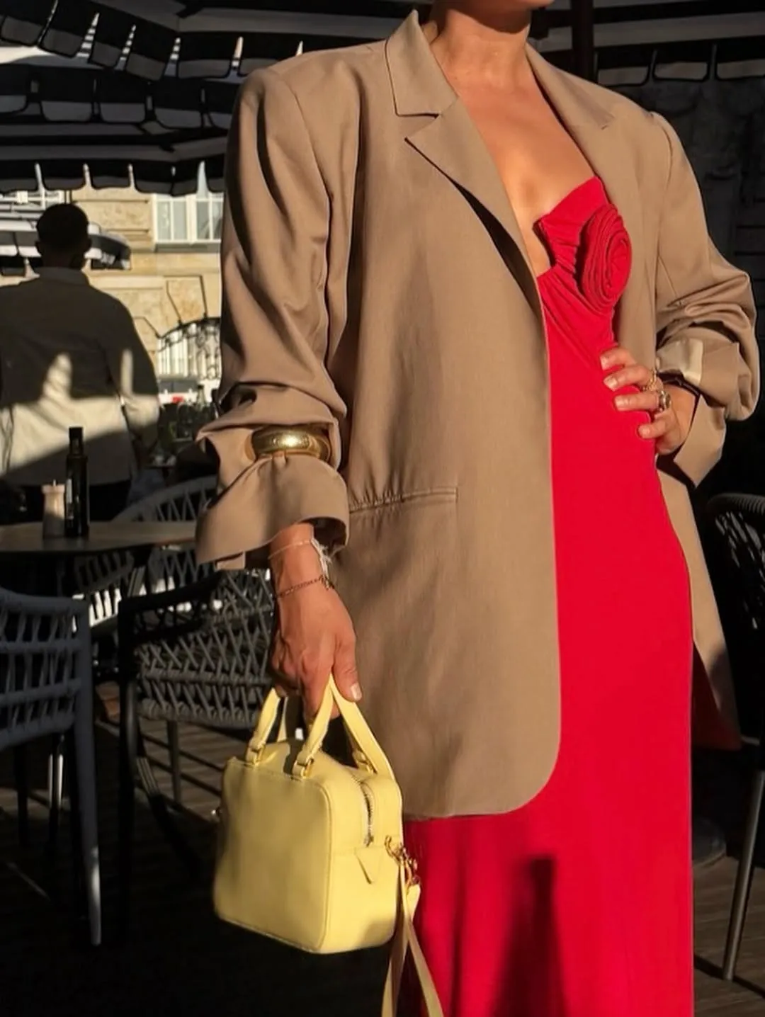 @annaaborisovna wearing beige blazer, red dress, and gold bangle