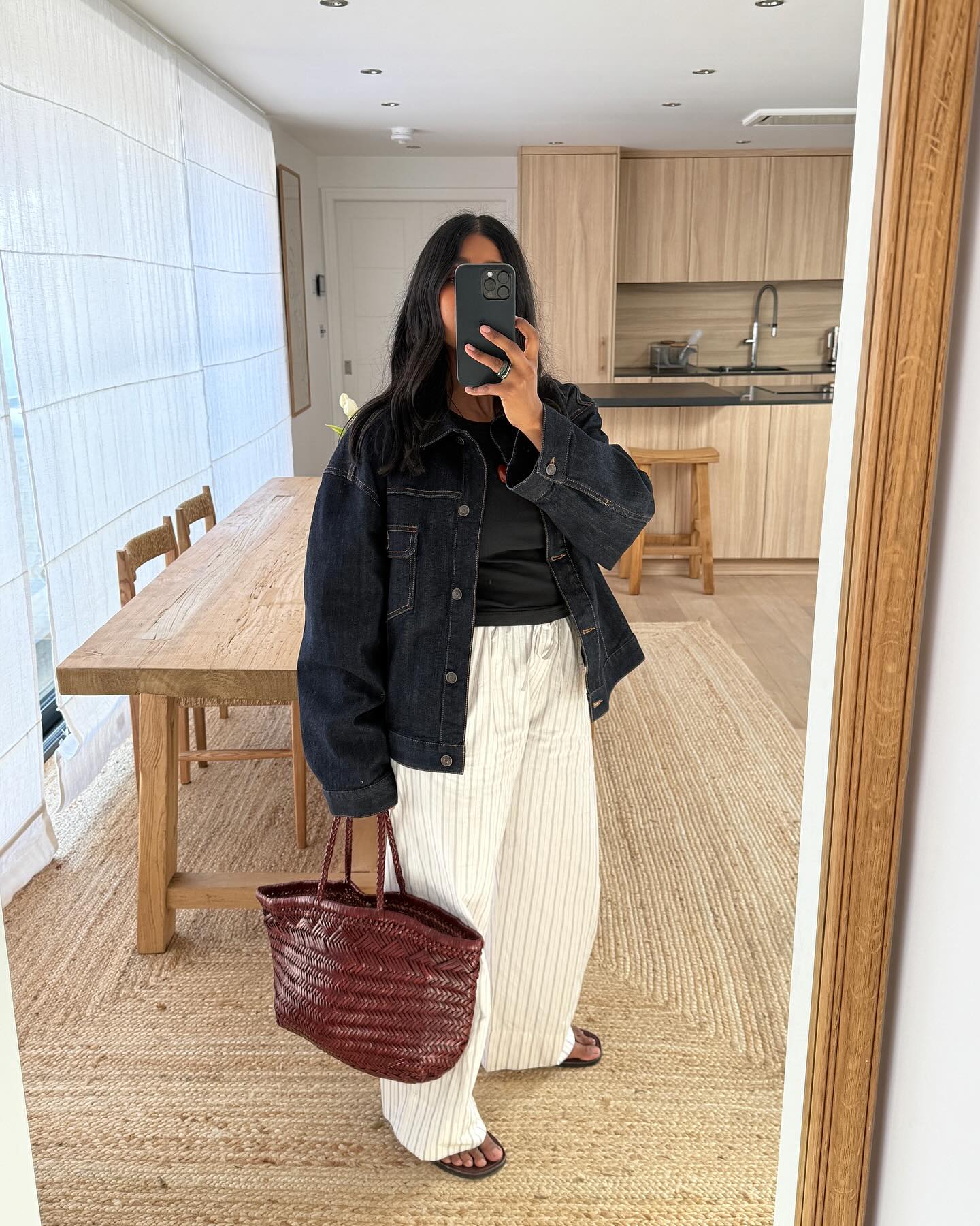 An image of @monikh wearing a woven leather bag, one of the biggest summer accessories.