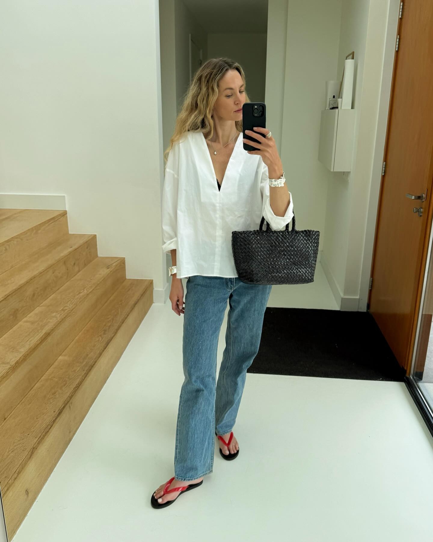 Influencer wearing a white top and jeans.