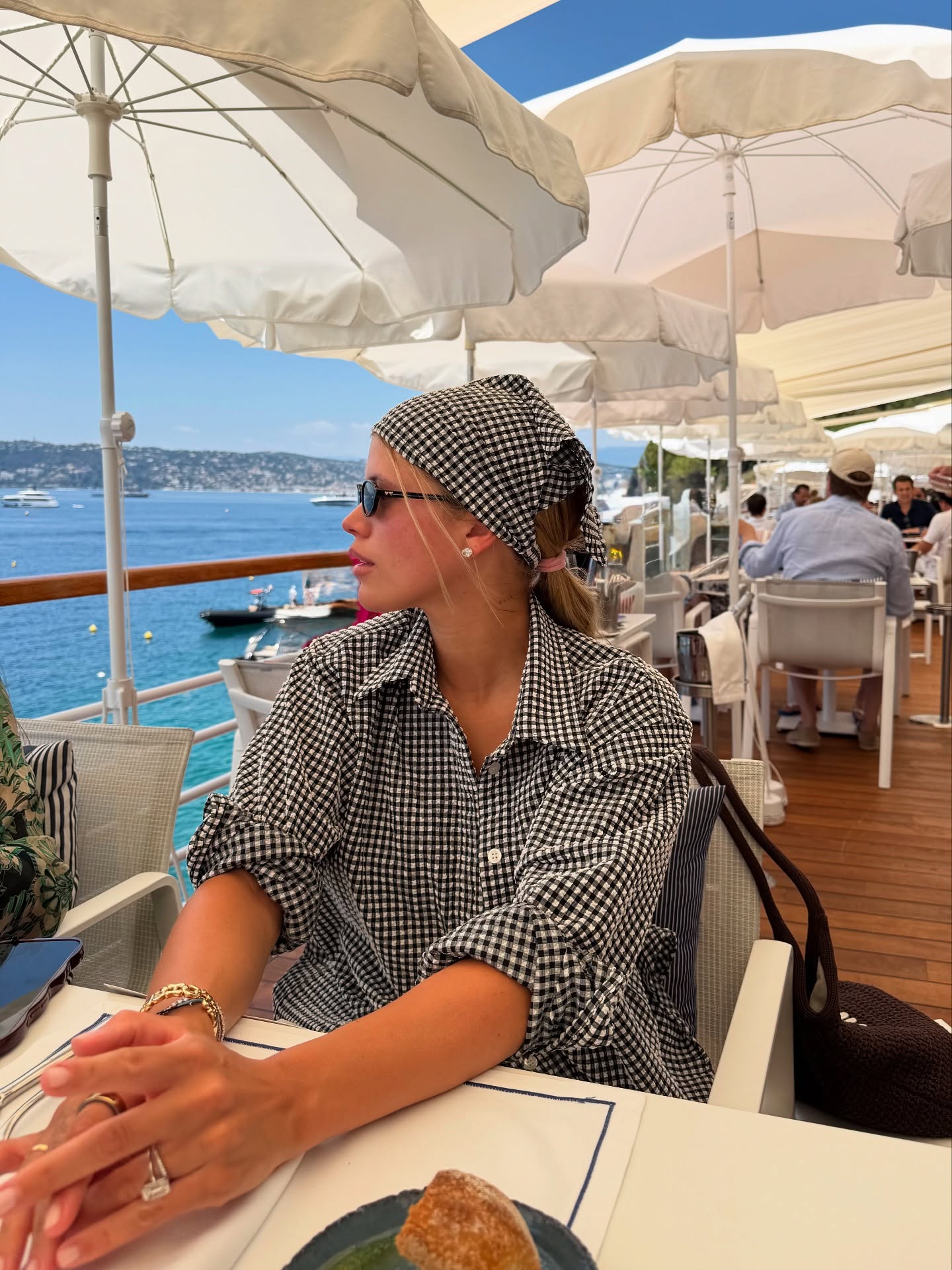 An image of @sofiagrainge wearing a bandana, one of the biggest summer accessories.