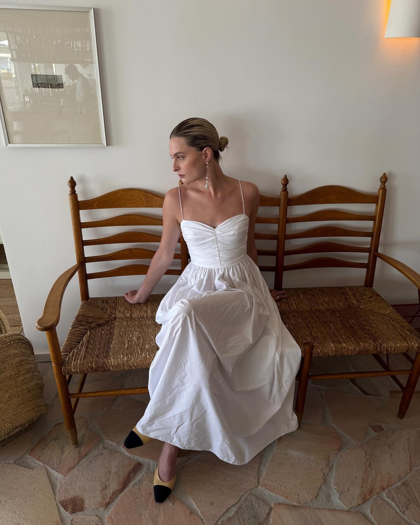 Influencer wearing a white cotton dress.