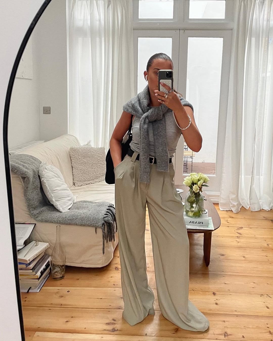 Woman wearing sweater styling idea for summer 2025.