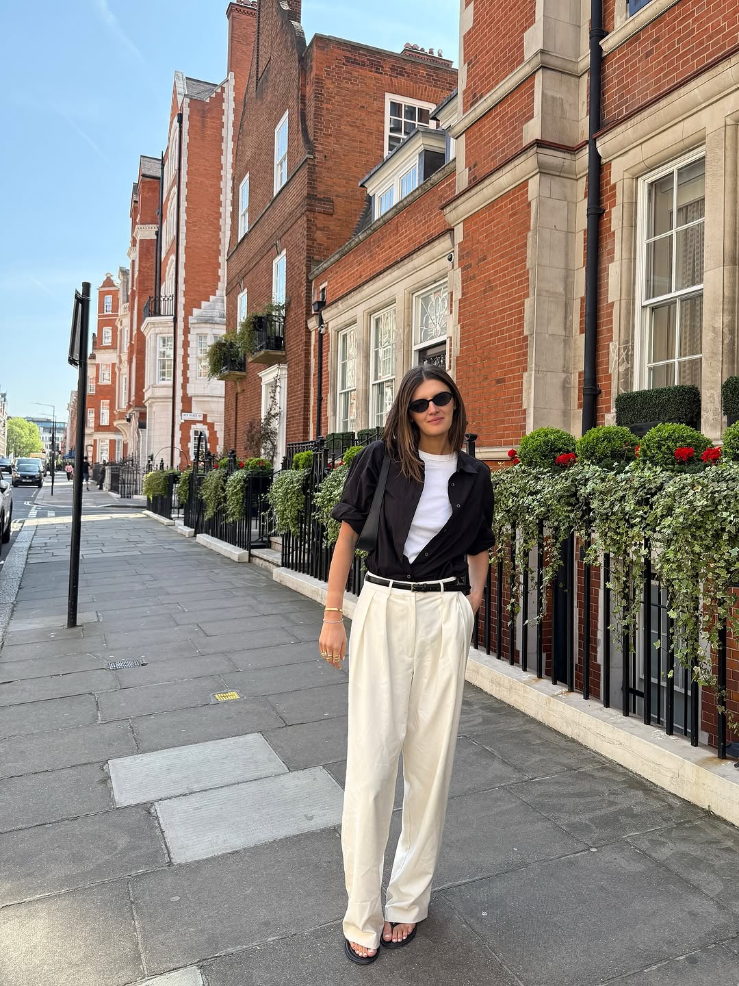 Woman wearing trouser pants and flip flops summer 2025.