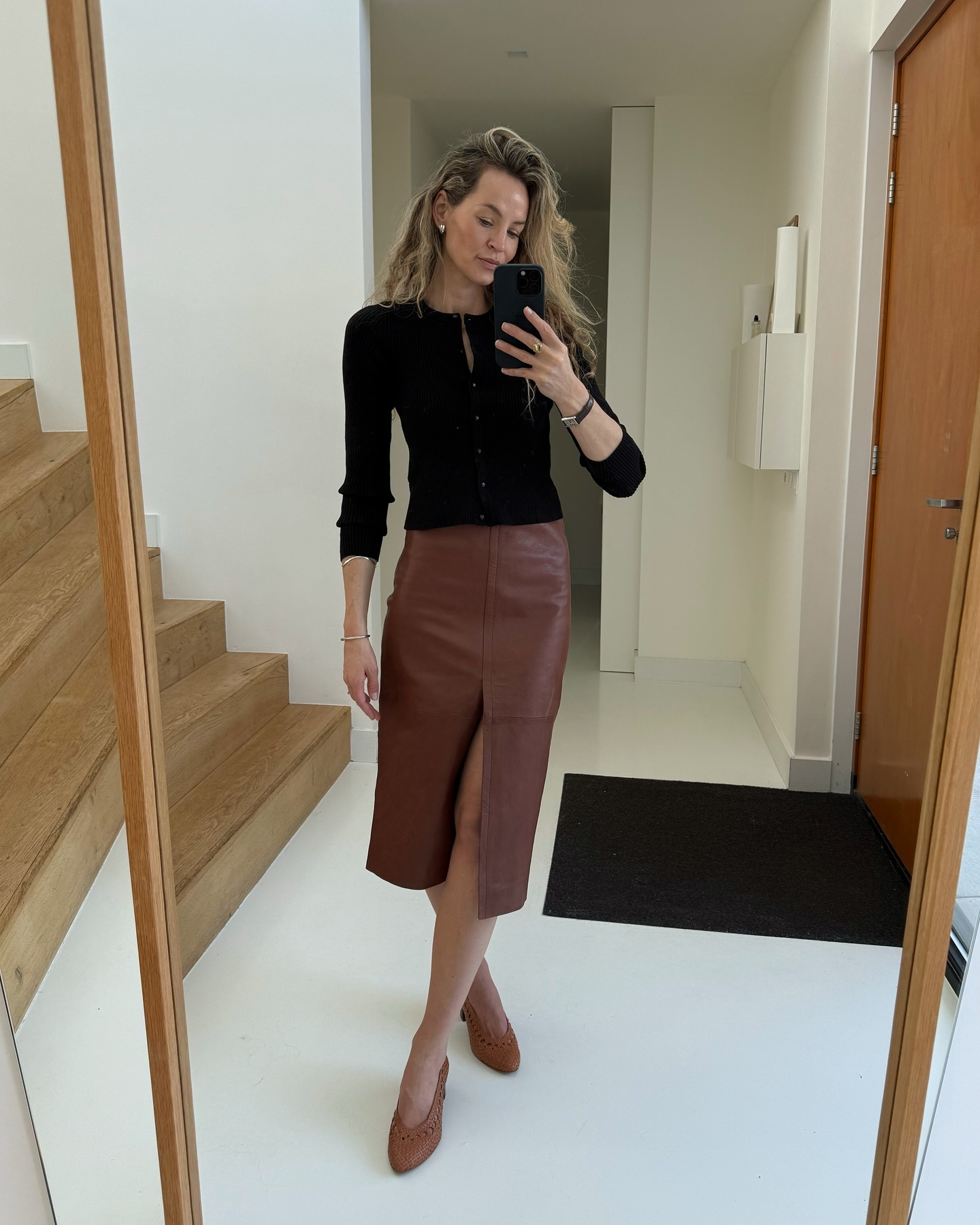 Fashion influencer wearing a cardigan-and-skirt outfit.
