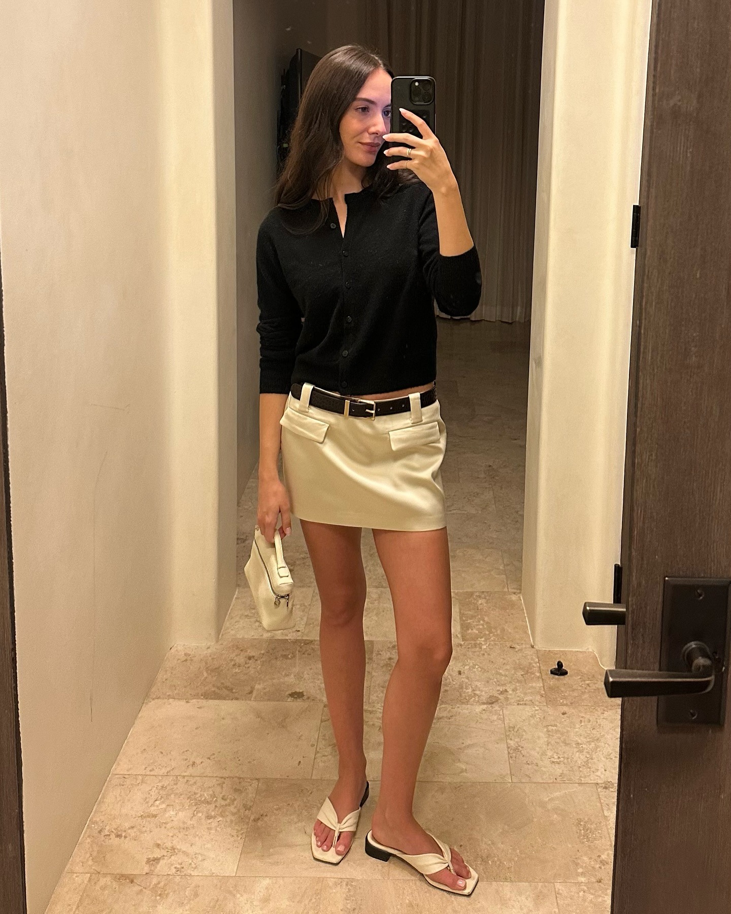 Fashion influencer wearing a cardigan-and-skirt outfit.