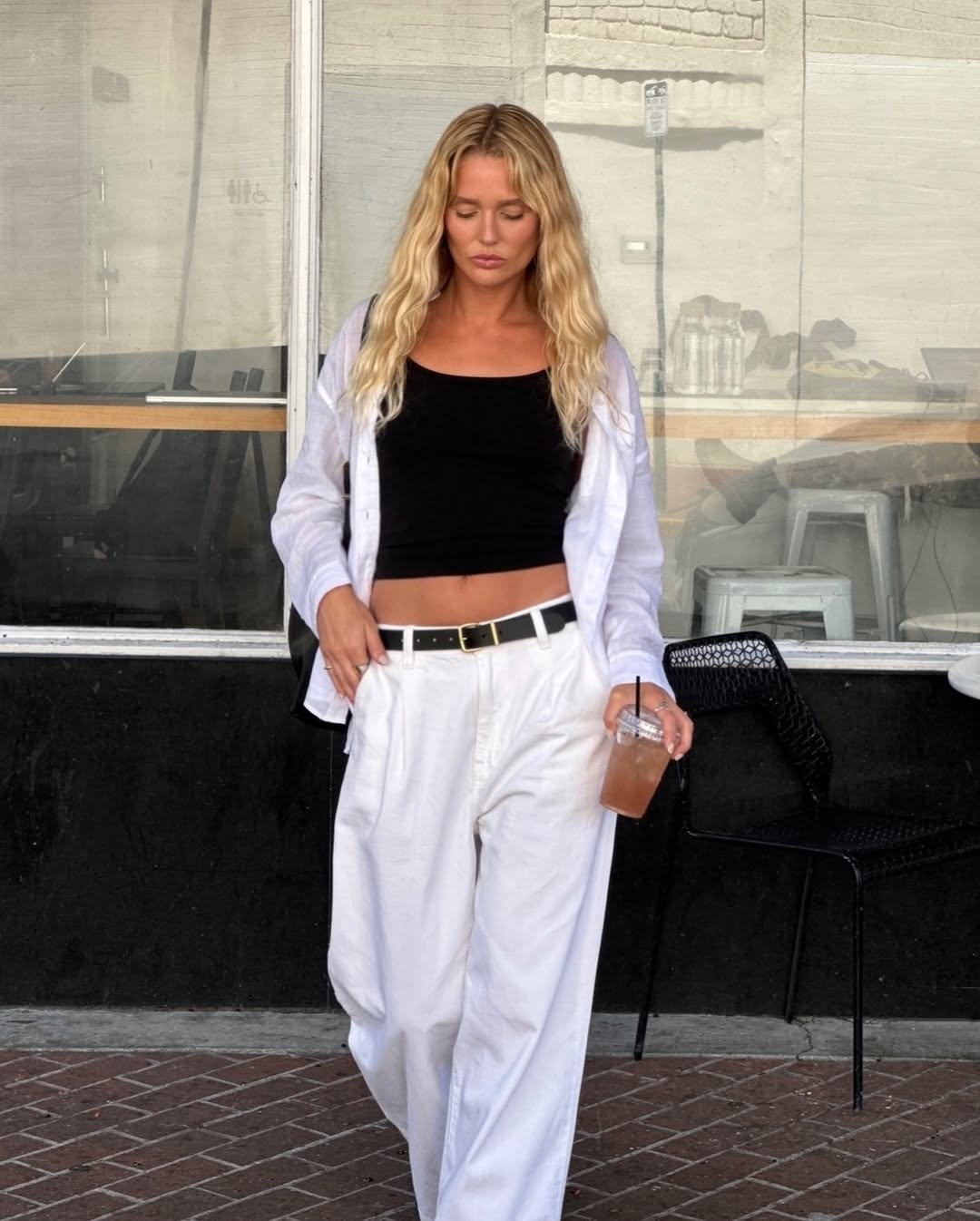 woman wearing white trousers black belt fall outfits 2025