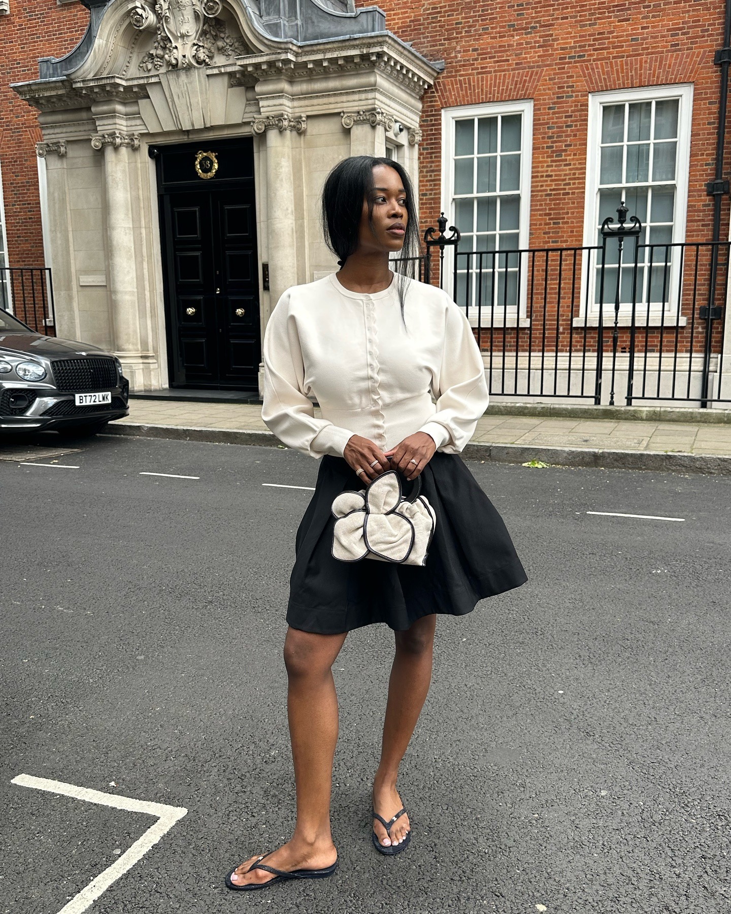 Fashion influencer wearing a cardigan-and-skirt outfit.