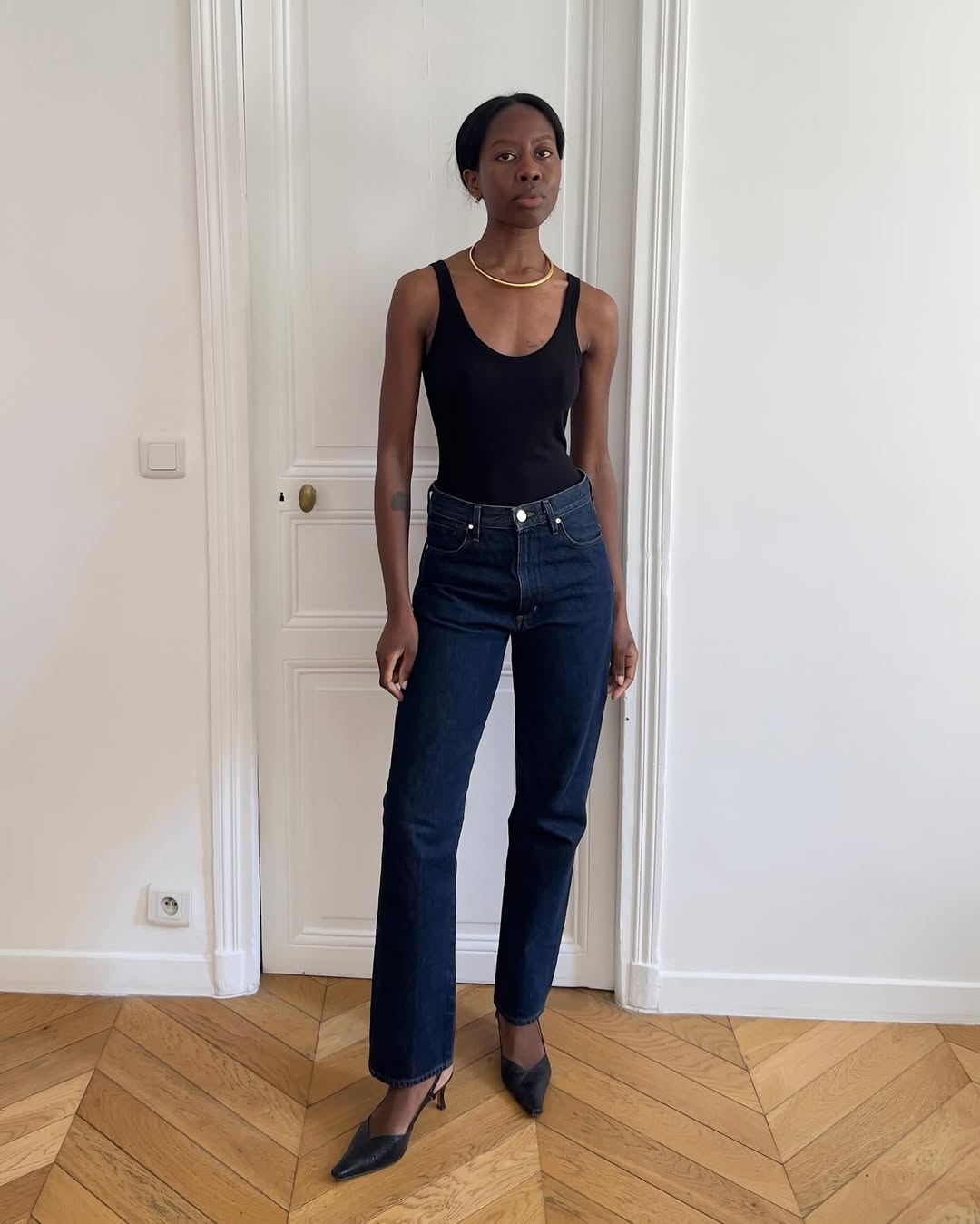 Sylvie Mus wearing a pair of dark-rinse jeans.