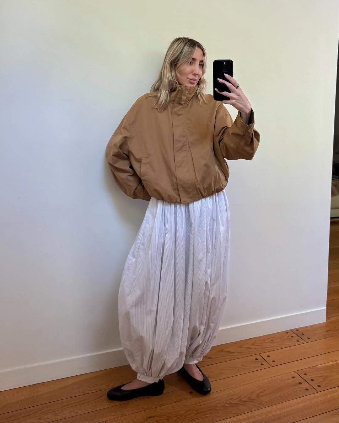 Woman wearing genie pants and a sporty jacket.