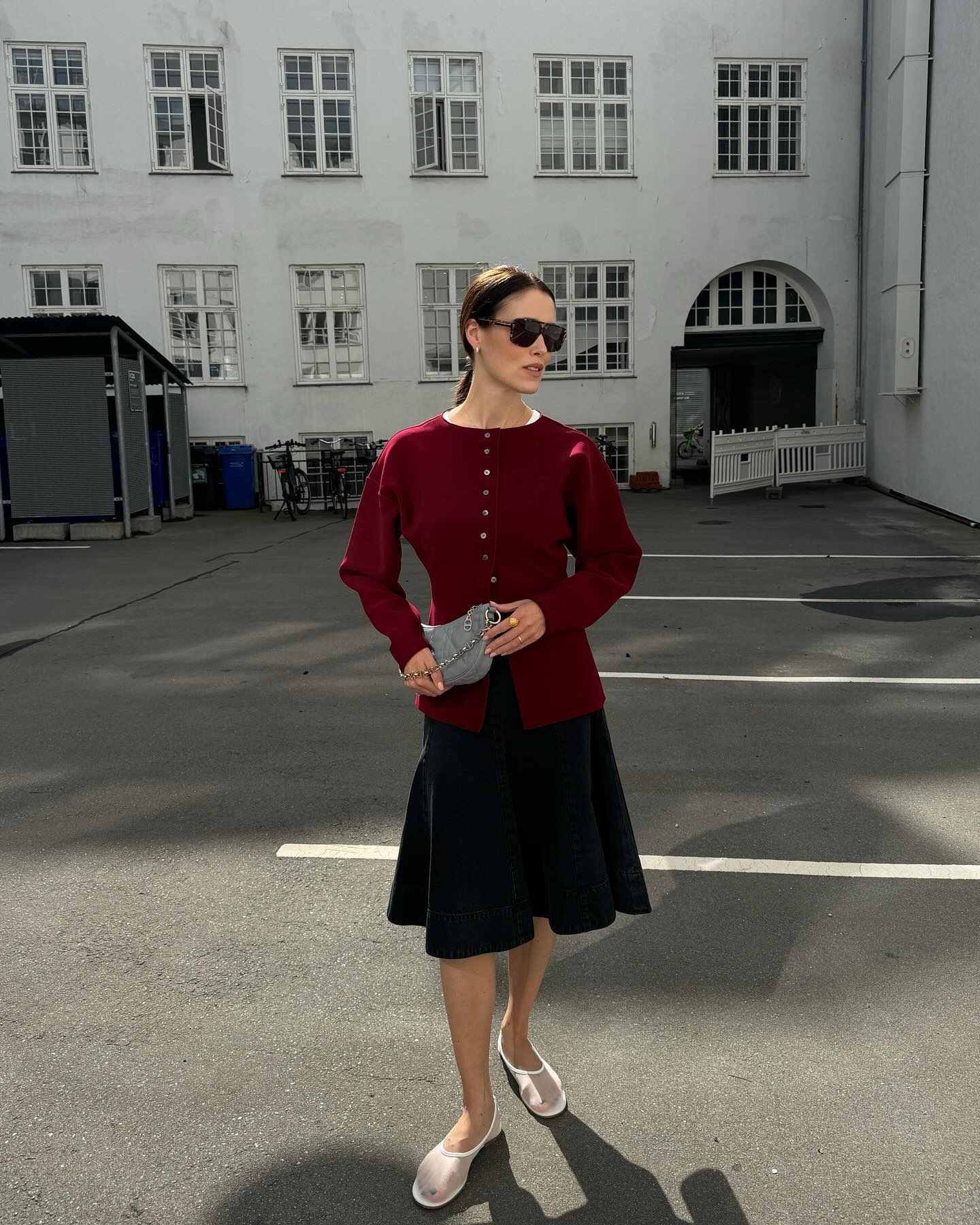 Fashion influencer wearing a cardigan-and-skirt outfit.