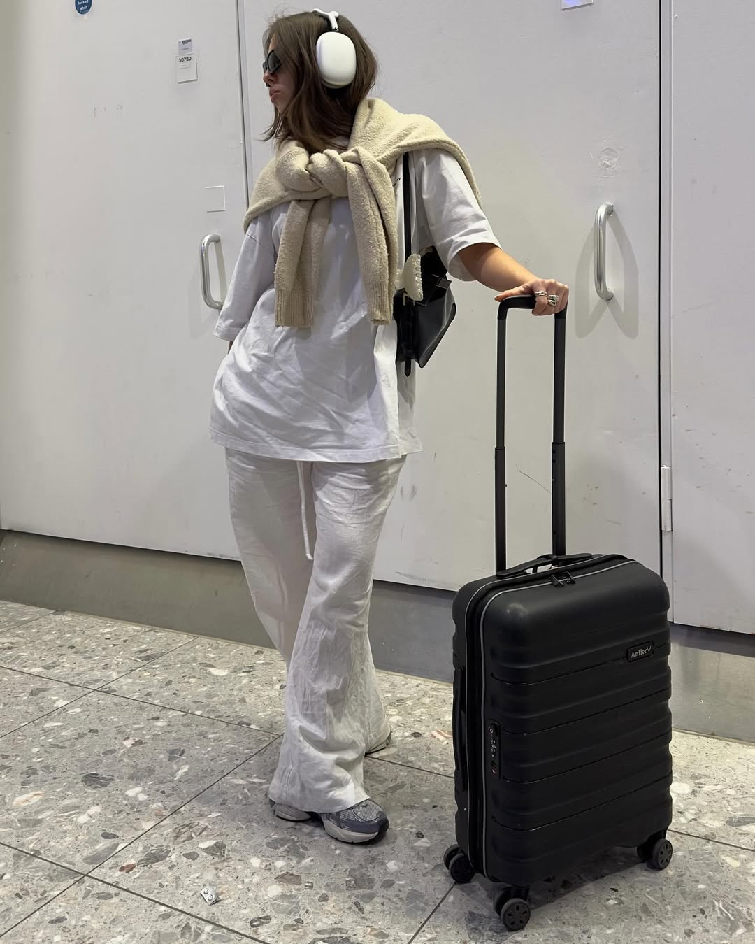 Woman wearing chic airport outfit 2025.