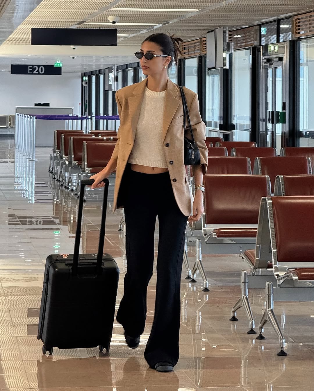 Woman wearing chic airport outfit 2025.