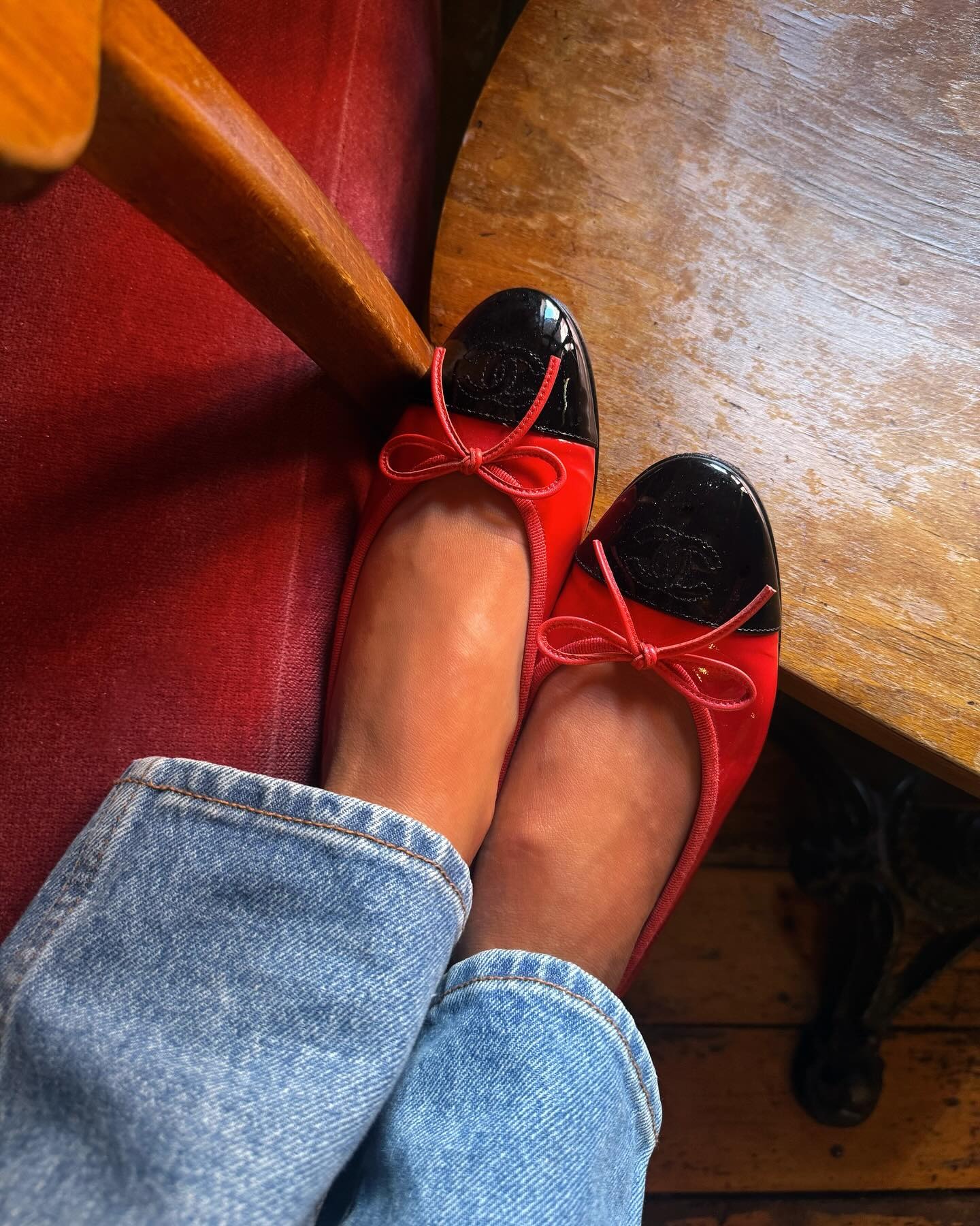 Influencer Emili Sindlev wearing red patent leather Chanel flats.