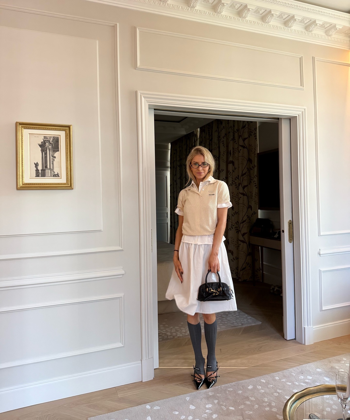 Influencer Caro Daur wearing a Miu Miu outfit with knee-high socks.