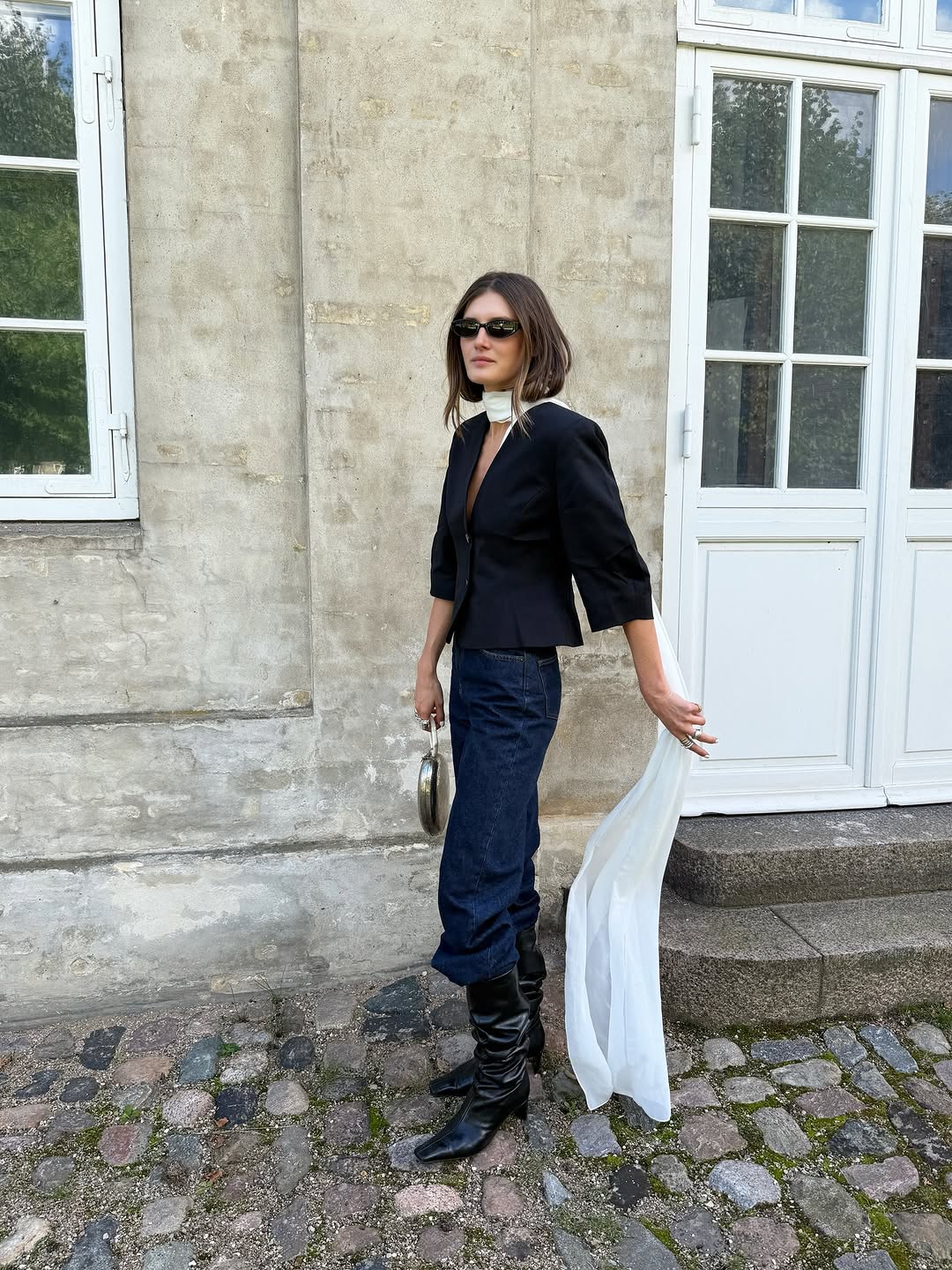 Woman wearing a 2025 slouchy boot outfit.