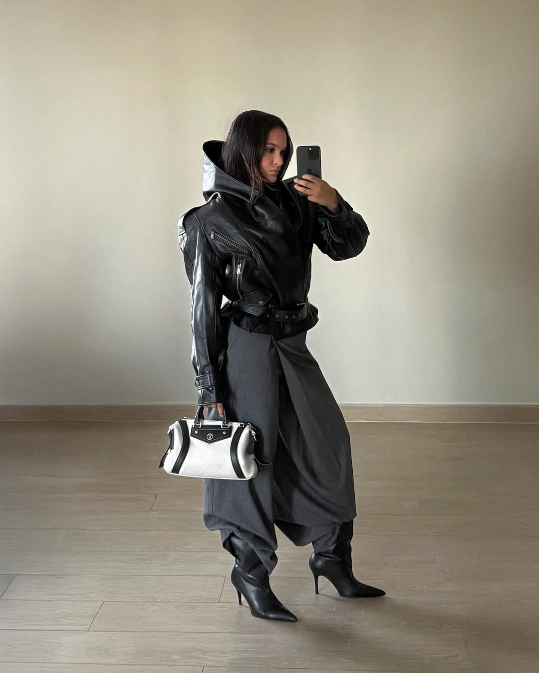 Woman wearing a 2025 slouchy boot outfit.