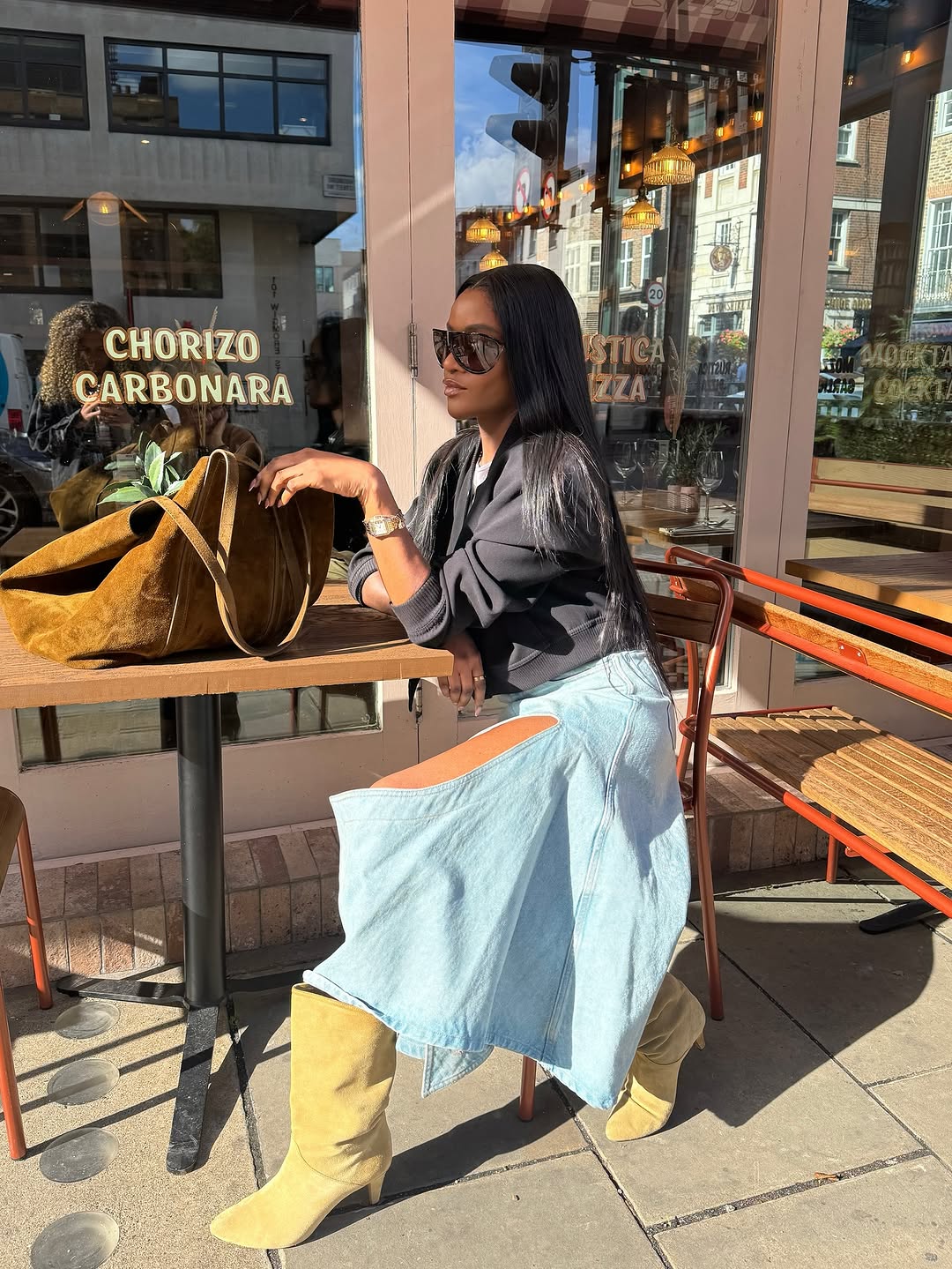 Woman wearing a 2025 slouchy boot outfit.