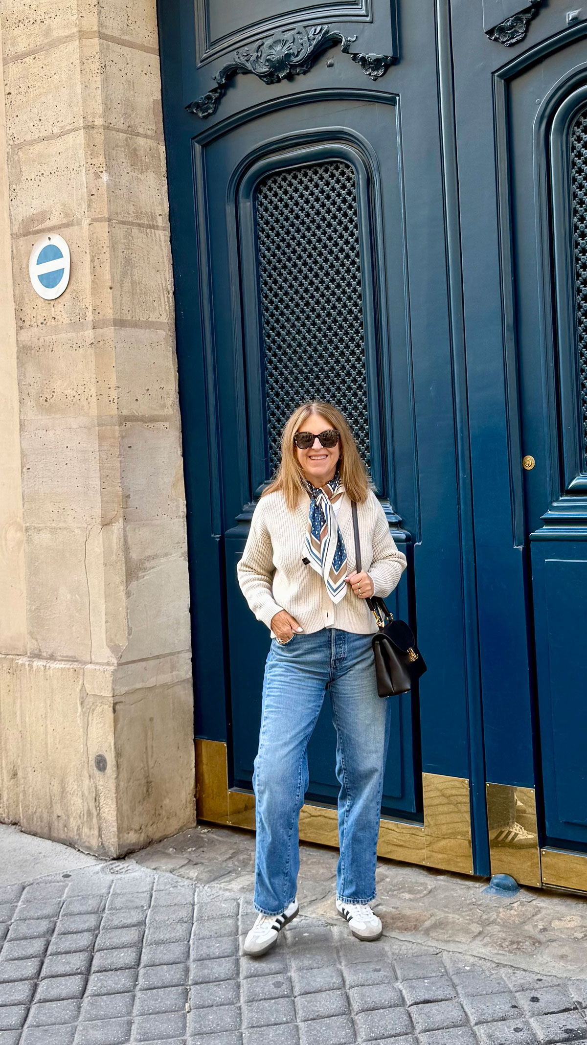 A Nordstrom stylist wearing a patterned neck scarf in Paris.