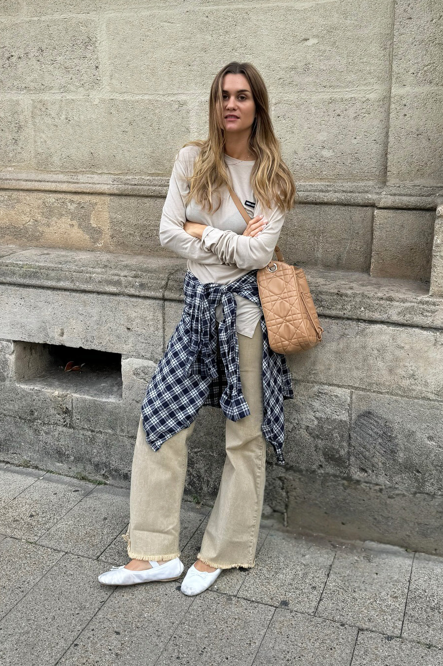 Influencer wearing a Miu Miu tee, plaid shirt, and khaki jeans