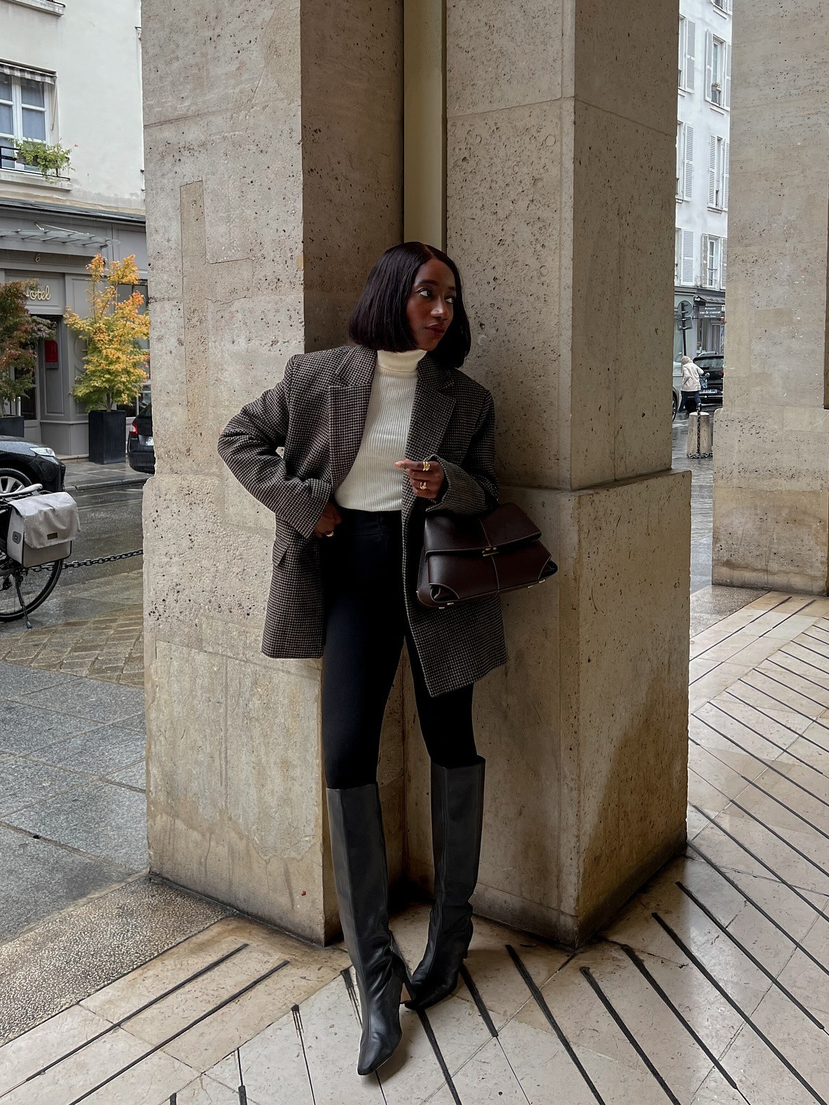 Influencer wearing leggings with a blazer, turtleneck, and knee boots