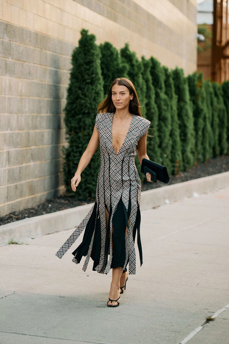 Woman wearing check print clothing during NYFW S/S 26.