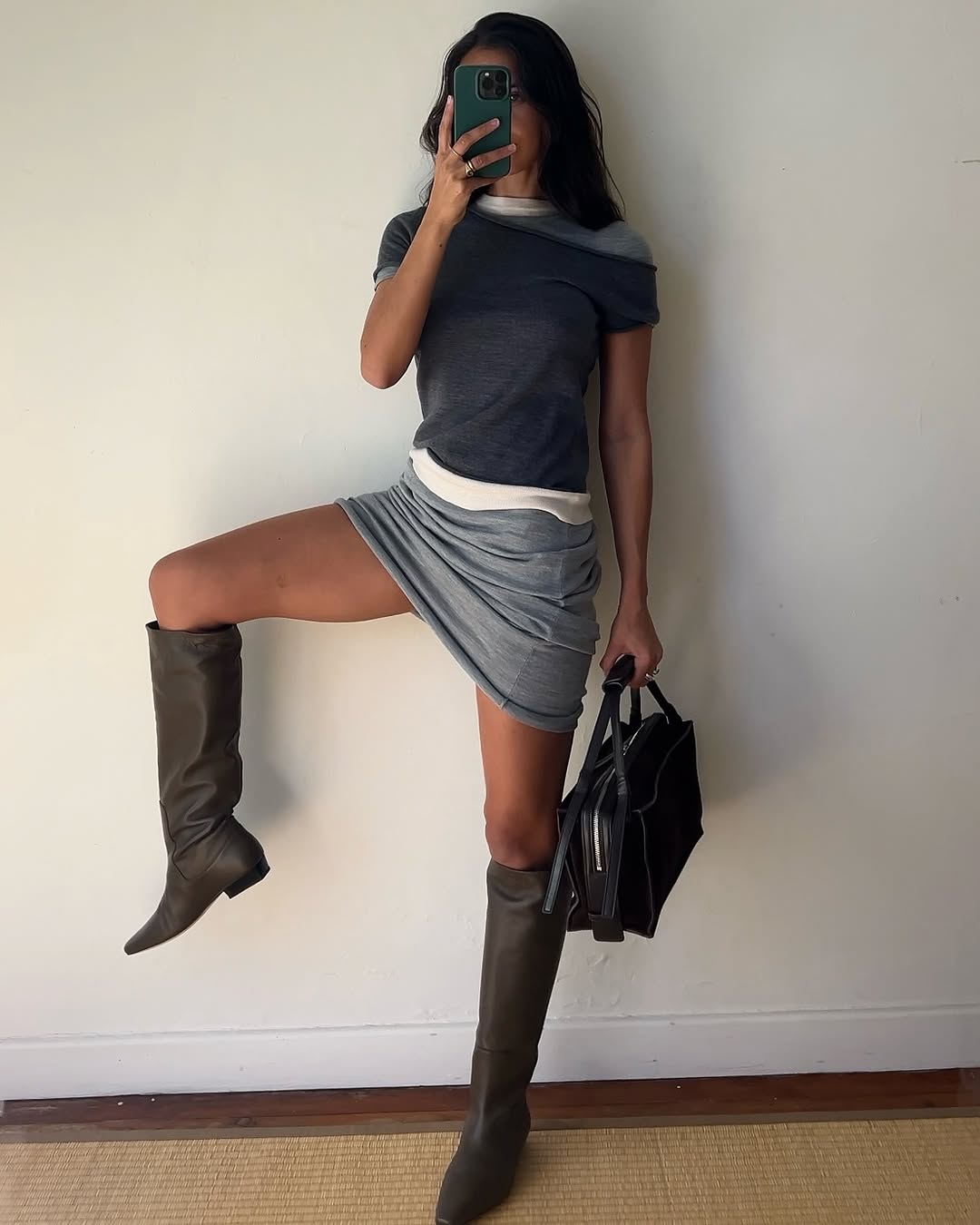 Woman wearing a 2025 slouchy boot outfit.