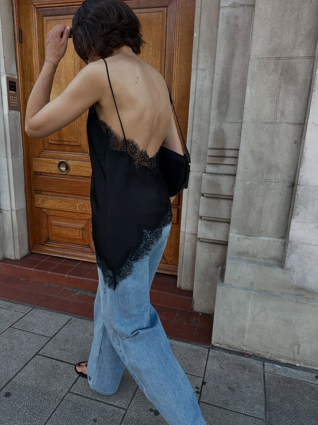 Woman wearing black lace going out top.