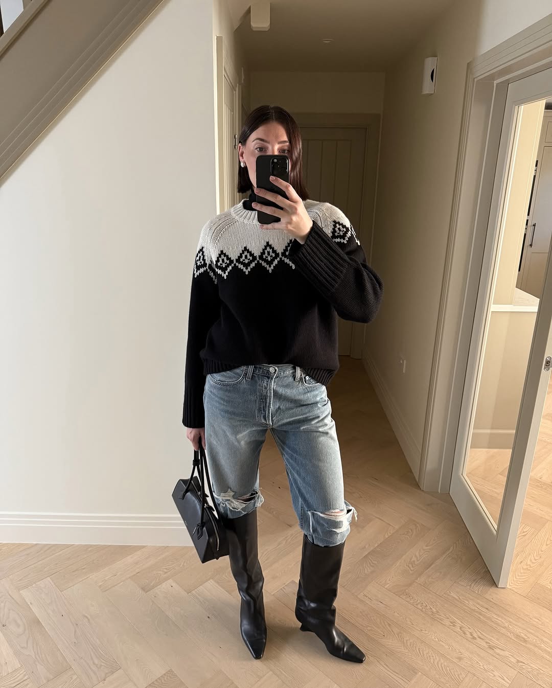 woman wearing fall denim boot tuck trend 2025