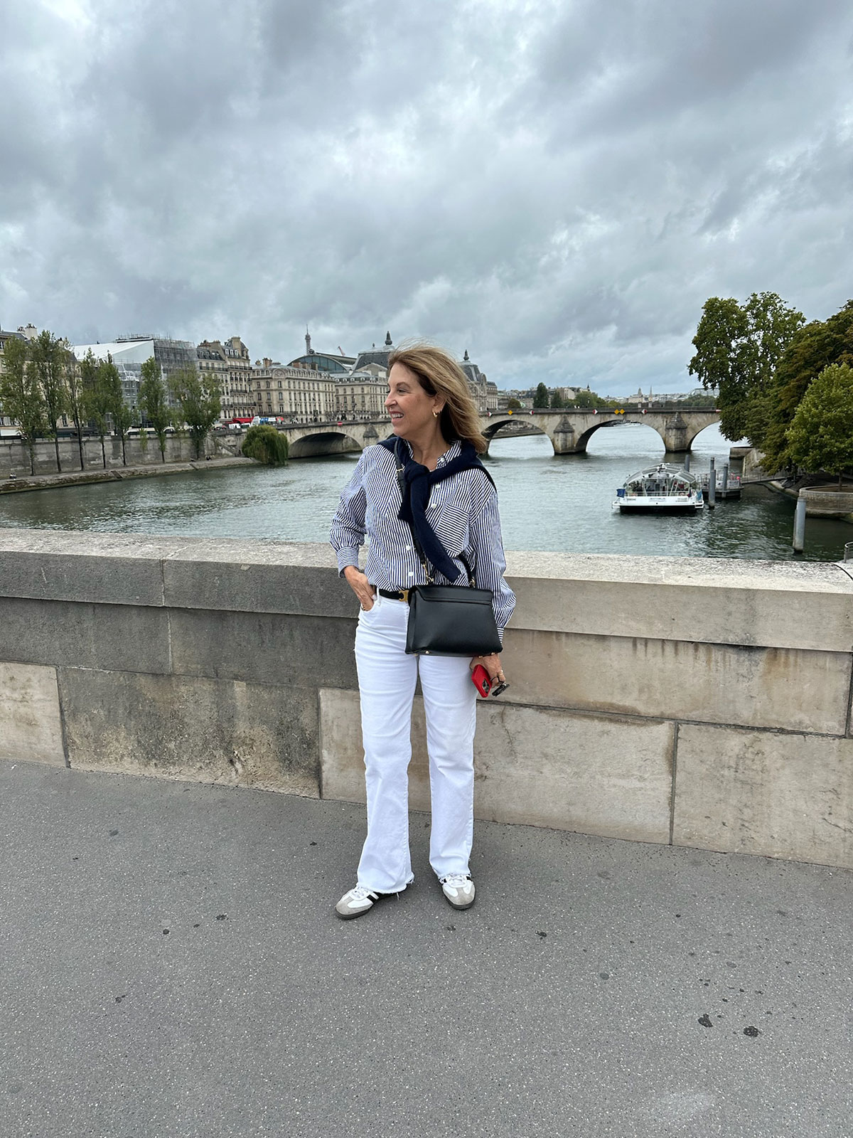 A Nordstrom stylist wearing straight-leg white jeans in Paris.
