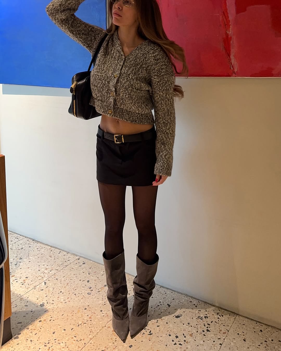 Woman wearing a 2025 slouchy boot outfit.