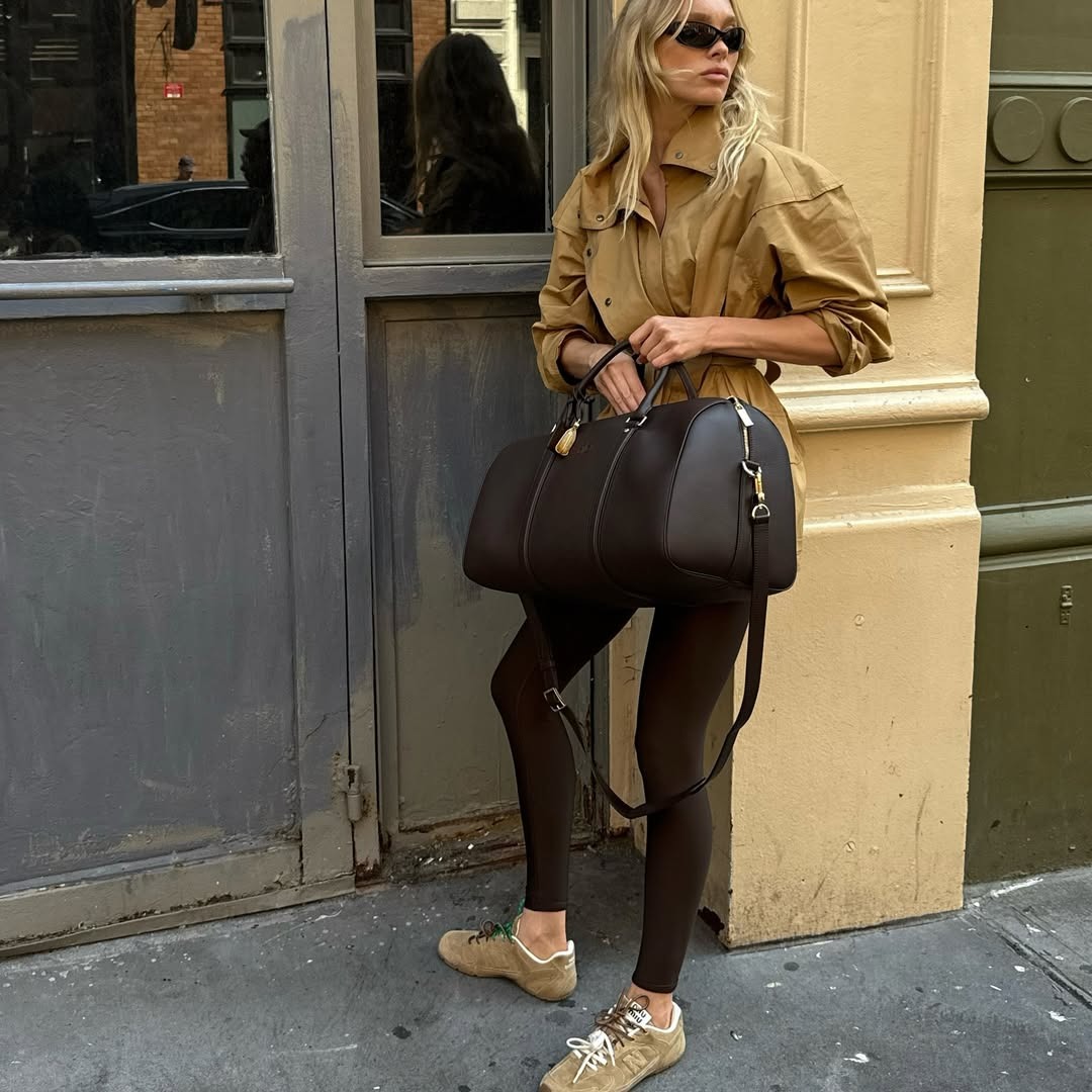 Elsa Hosk wearing leggings with a trench and suede sneakers