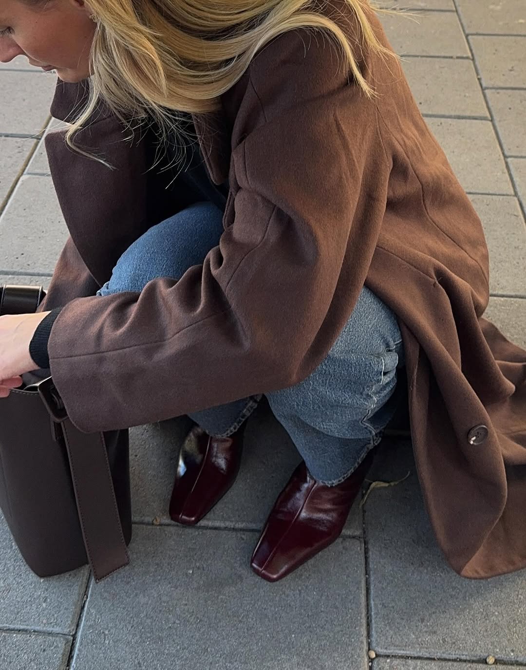 Woman wearing burgundy shoe outfit 2025.