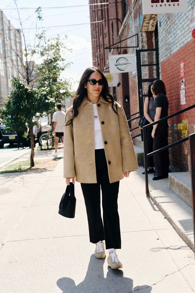 Woman wearing tan outerwear during NYFW S/S 26.