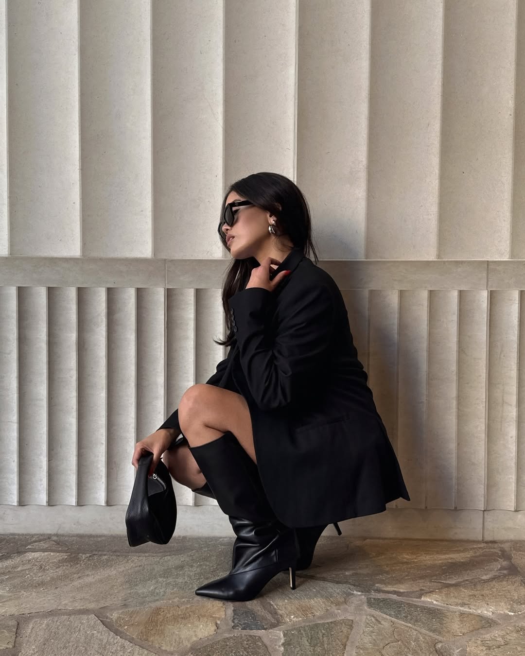 Woman wearing a 2025 slouchy boot outfit.