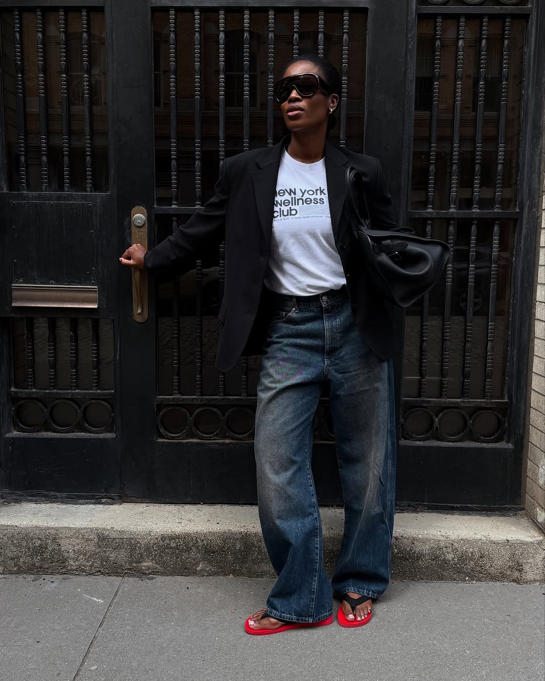 Woman wearing fall blazer with jeans outfit 2025.