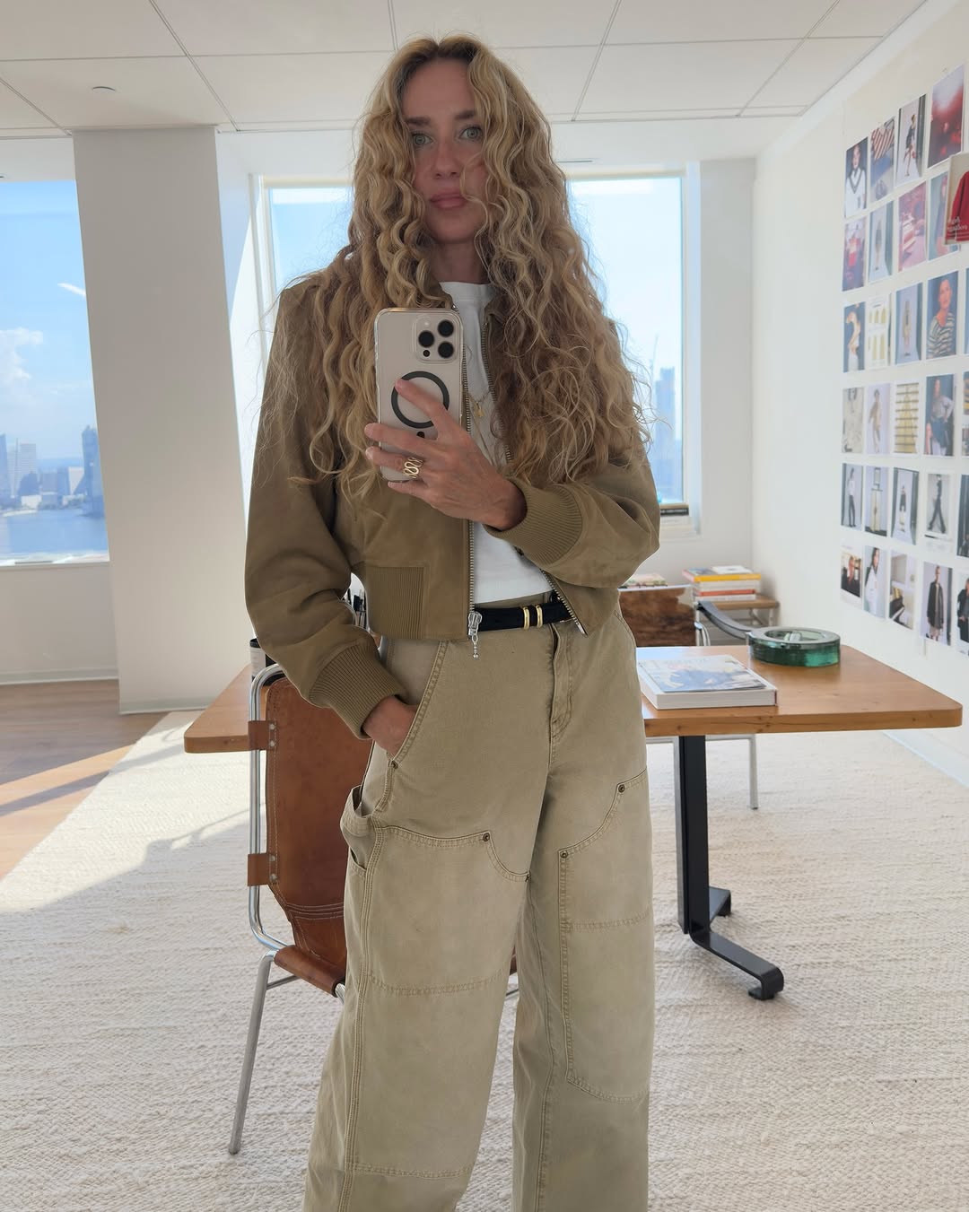 Woman wearing a tan jacket with jeans in a fall 2025 outfit.