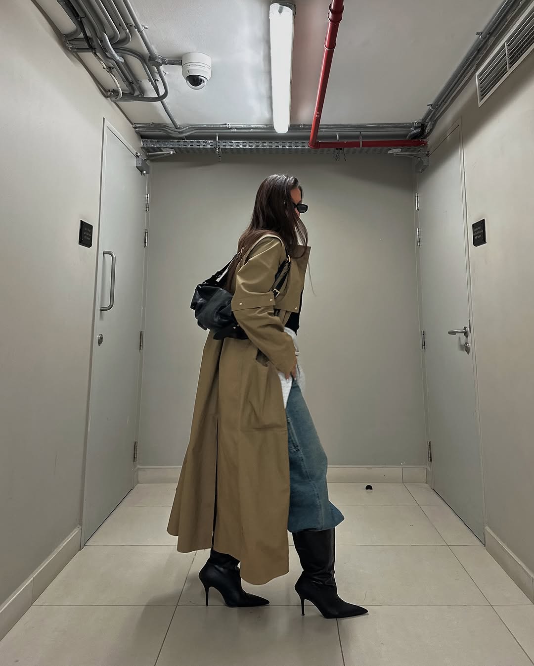 woman wearing fall denim boot tuck trend 2025