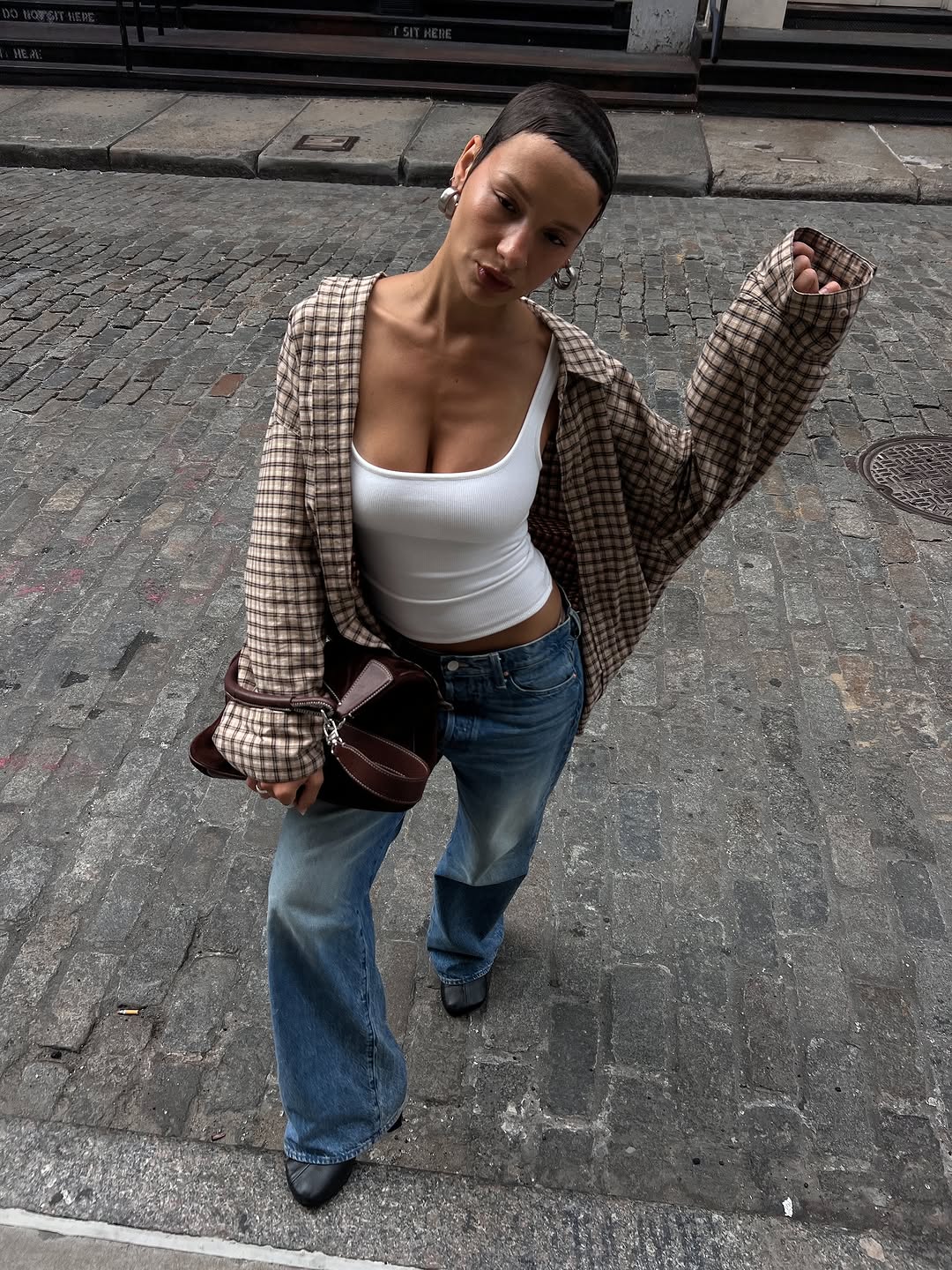 woman wearing fall dirty denim trend 2025