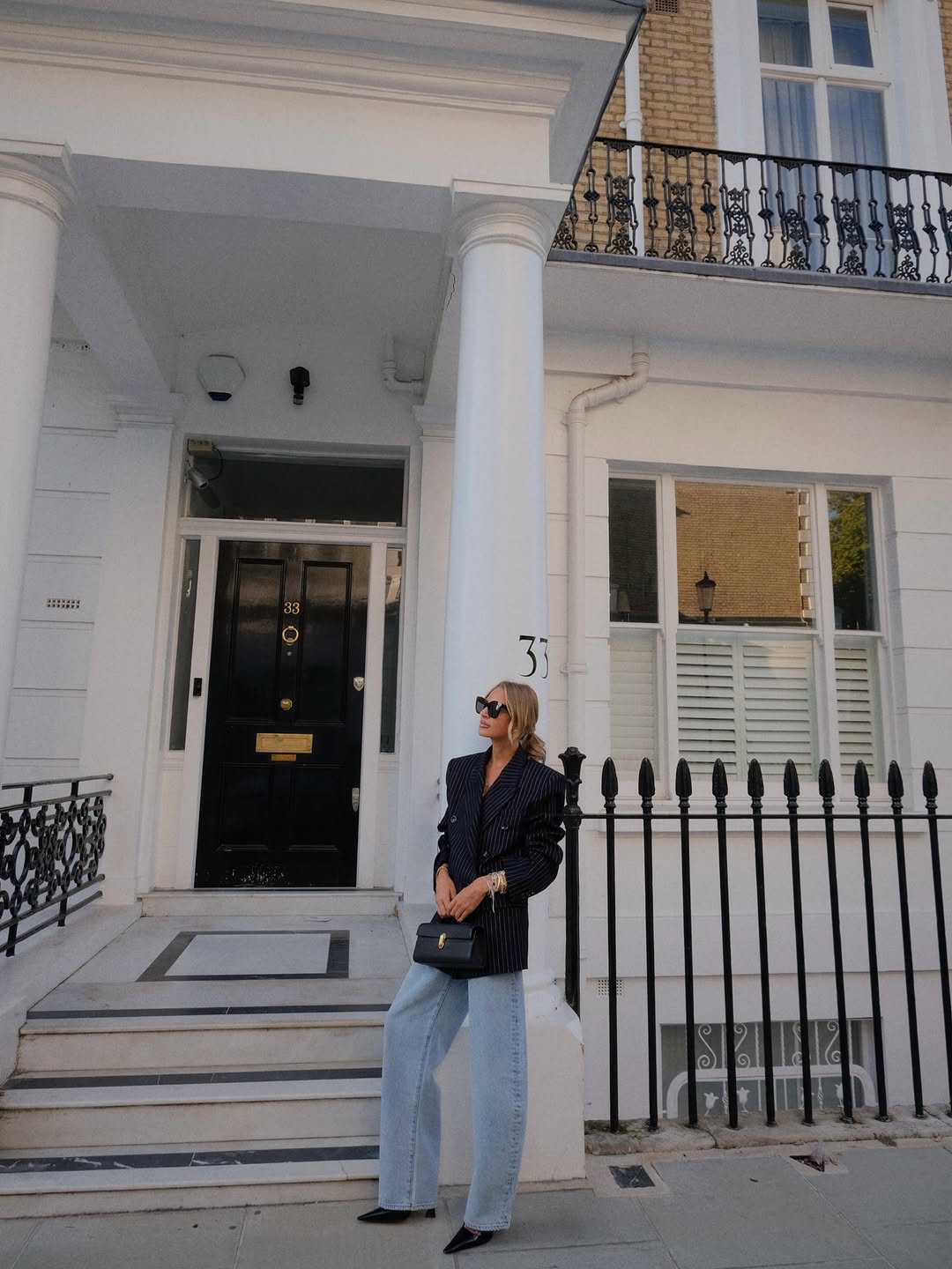 Woman wearing fall blazer with jeans outfit 2025.